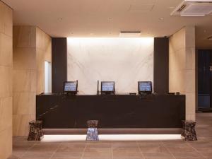 a lobby with a counter with two laptops on it at Hotel Shuranza MAKUHARI BAY in Chiba +83 photos