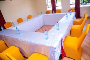 a long table with bottles of water sitting on it at Museum View Hotel Kisumu in Kisumu