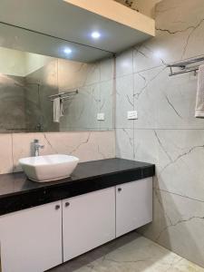 a bathroom with a sink and a mirror at Vidhyashree Illam in Madurai +58 photos