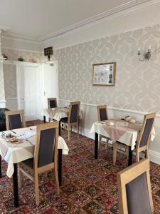 a restaurant with tables and chairs in a room at The Sandrock in Clacton-on-Sea