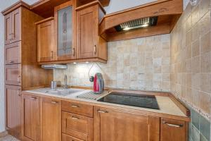 a kitchen with wooden cabinets and a sink at Villa Marittima in Izola +84 photos