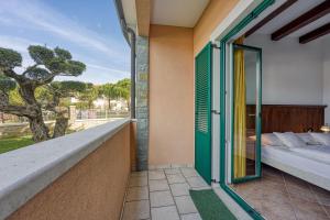 a balcony with a bed and a window at Villa Marittima in Izola