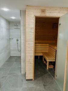a bathroom with a sauna with a bench in it at Alm Studio 22 - Thymian - Ferienwohnung in Fischen in Fischen