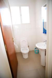 a bathroom with a toilet and a sink at CENTRE PASTORAL SAINT AUGUSTIN RWAMAGANA in Rwamagana +110 photos