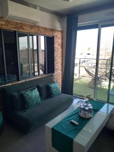 a living room with a couch and a table at Appartement de L'Espiguette in Le Grau-du-Roi