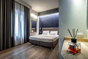 A bed or beds in a room at Blu Notte Guest House