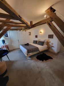 a bedroom with a large bed in a attic at Domaine de charme - Les Places in Lassay-sur-Croisne +58 photos