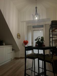 a dining room with a table and a staircase at La casa degli innamorati in Bari