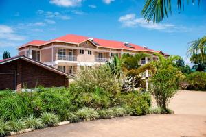 a large house with a red roof at CENTRE PASTORAL SAINT AUGUSTIN RWAMAGANA in Rwamagana