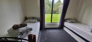 Postel nebo postele na pokoji v ubytování Tullah HideAway