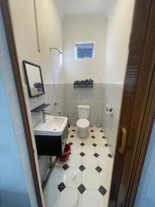 a small bathroom with a sink and a toilet at Laman tokma in Kota Bharu