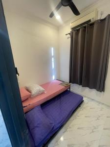 a bed in a room with a ceiling fan at Laman tokma in Kota Bharu