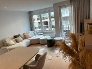 een woonkamer met een bank en een tafel bij Bayaux centrum Knokke in Knokke-Heist