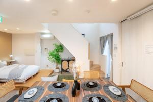 a dining room with a table and a bed at JR EBISU walk for 5min in Tokyo