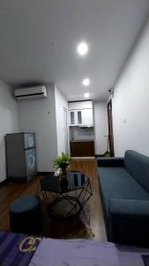 a living room with a blue couch and a table at 18 ngõ 154 Đình Thôn in Hanoi