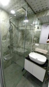 a bathroom with a shower and a sink at 18 ngõ 154 Đình Thôn in Hanoi
