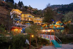 a large building with a playground in front of it at Zostel Plus Mussoorie- Kempty in Mussoorie