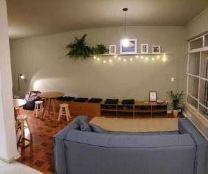a living room with a blue couch and a table at Jardim Secreto in Sao Paulo