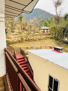 un balcón de una casa con vistas a la montaña en Isha Villa, en Pālampur