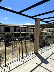 a fence on a deck with a building in the background at 9D - appartement Bonifacio Corse in Bonifacio +16 photos