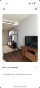 a room with a bed and a dresser and a television at Oceanview apartment in The Arena Cam Ranh resort in Îlot Ba Ninh