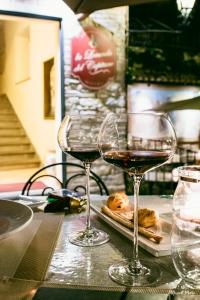 two glasses of wine sitting on a table at La Locanda Del Capitano in Montone