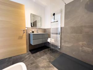 a bathroom with a sink and a mirror at Apartment Rosenheim in Pianizza di Sotto