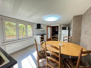 a kitchen and dining room with a wooden table and chairs at AlpenHaus, farmhouse in Triesenberg