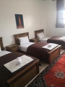 a room with three beds in a room at Auberge Kasbah Amoun in Taliouine