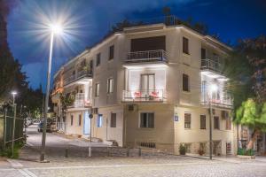 a large building on a street with a street light at Thissio Acropolis Historic Flat 1 in Athens