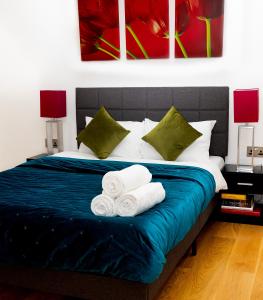 une chambre avec un lit avec des serviettes dessus dans l'établissement Peninsula Life- Stylish Greenwich 1bed Flat, à Londres