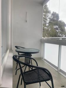 a table and a chair in a room with a window at HUTTUNEN 2 - Ihqu kaksio mahtavalla sijainnilla! in Iisalmi