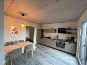 a kitchen with a table and chairs in a room at Hegau Apartment in Tengen