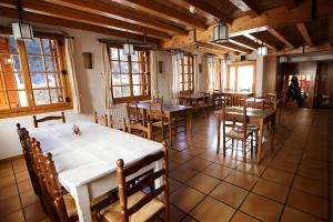a dining room with tables and chairs and windows at HOTEL LAMOGA in Llavorsí +34 photos