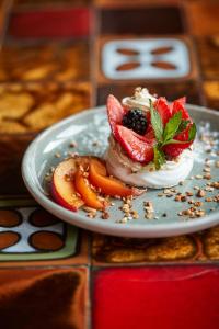 a plate of food with fruit and whipped cream at Hôtel du Grand Capelet in Belvédère +33 photos