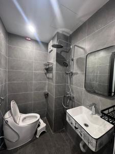 a bathroom with a toilet and a sink at Phương house in Long Biên