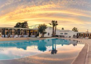 a large swimming pool in front of a building at Tenuta San Marco in Noto