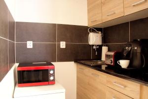 a kitchen with a red microwave on a counter at Rest- Pokoje z Łazienkami in Gdynia