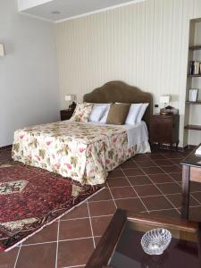 a bedroom with a bed and a tiled floor at Il Casale di Riardo Luxury B&B in Riardo