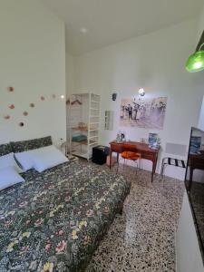 a bedroom with a bed and a desk at Maddrigga di Luna in Selargius