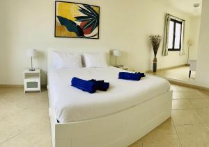 1 cama blanca grande con 2 almohadas azules. en Casa Angelita Y Pablo, en Playa Blanca 22 fotos más