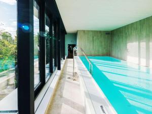 an indoor swimming pool with a swimming pooliteratorhaarhaarhaarhaarhaarhaarhaar at Grand Hotel Bregenz - MGallery Collection in Bregenz