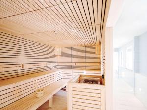 an empty sauna with a wooden ceiling at Grand Hotel Bregenz - MGallery Collection in Bregenz