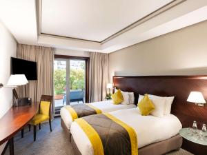 Ένα ή περισσότερα κρεβάτια σε δωμάτιο στο Le Diwan Hotel Rabat - MGallery Collection