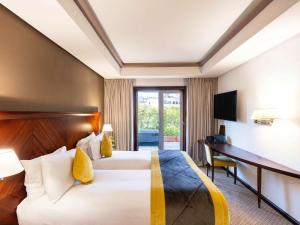 Ένα ή περισσότερα κρεβάτια σε δωμάτιο στο Le Diwan Hotel Rabat - MGallery Collection