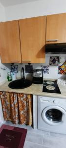 a small kitchen with a sink and a stove at Il Rifugio sul Mare in Stintino