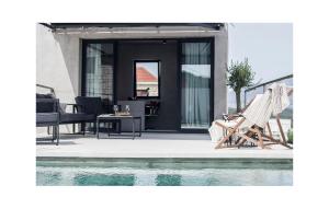 a pair of deck chairs sitting next to a pool at Villa Breakaway in Selca