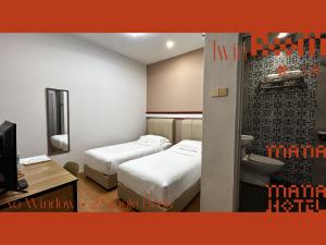 Postel nebo postele na pokoji v ubytování Mana Mana Hotel • Melaka •