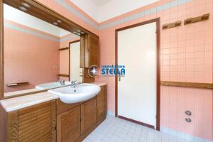 a pink bathroom with a sink and a mirror at Casa Rialto in Lido di Jesolo +21 photos