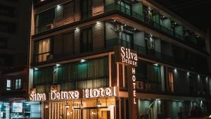 a building with a sign that reads silver dance hotel at SİLVA DELUXE Hotel in Mezitli